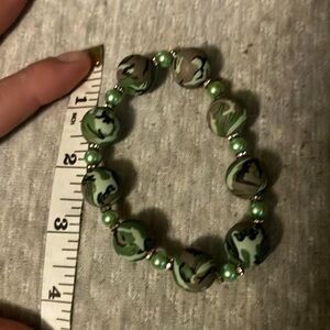Green pearls with sparkling cubic zirconia and camouflage beads bracelet.